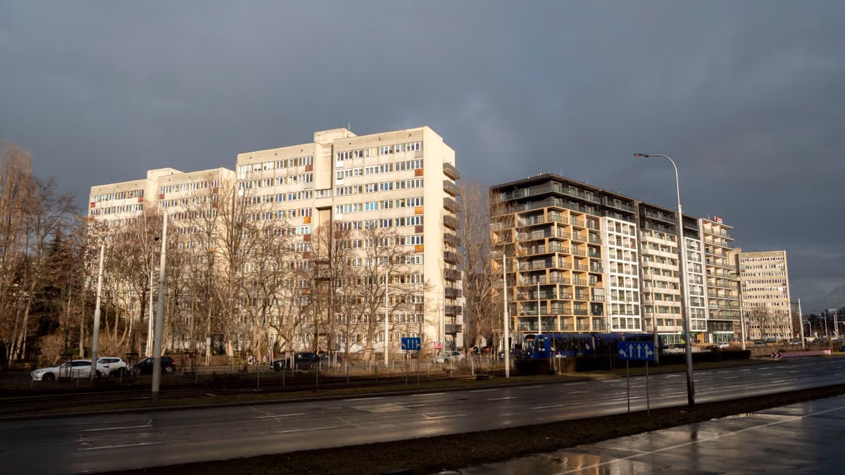 City apartment buildings with cloudy sky, showcasing urban architecture.